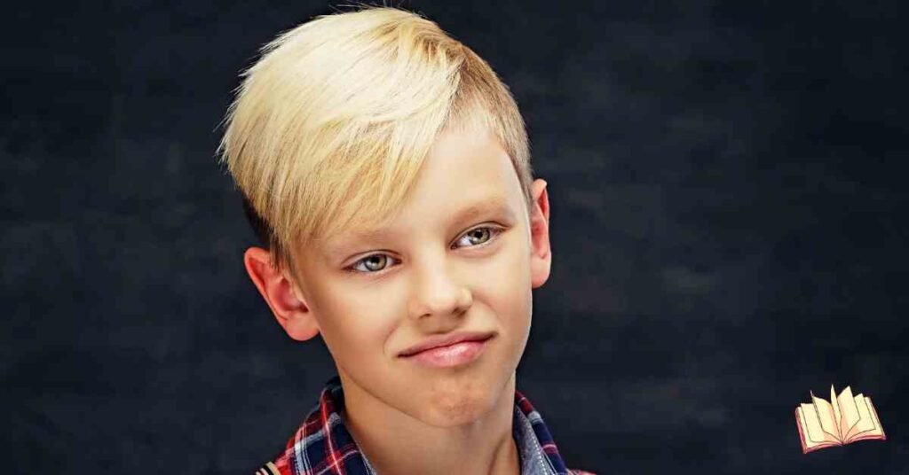 A young boy showcasing short and easy haircuts for boys, featuring a stylish blonde side-swept fringe with tapered sides against a dark textured background