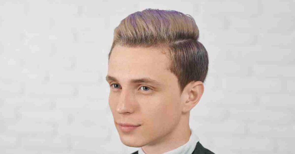 Boy with a side part with fade haircut, featuring a sleek combed top and clean faded sides for a modern and polished look